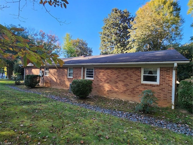 view of home's exterior with a yard