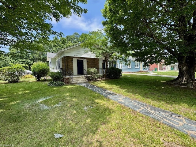 1101 Forrest St, High Point, NC 27262 - view of front of home with brick siding and a front yard