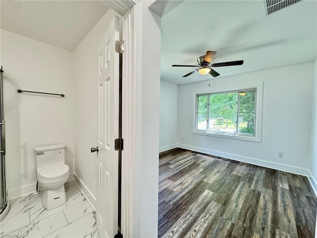 1101 Forrest St, High Point, NC 27262 - bathroom featuring toilet, ceiling fan, baseboards, and an enclosed shower