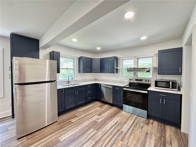 1101 Forrest St, High Point, NC 27262 - kitchen with appliances with stainless steel finishes, a sink, light countertops, light wood finished floors, and recessed lighting