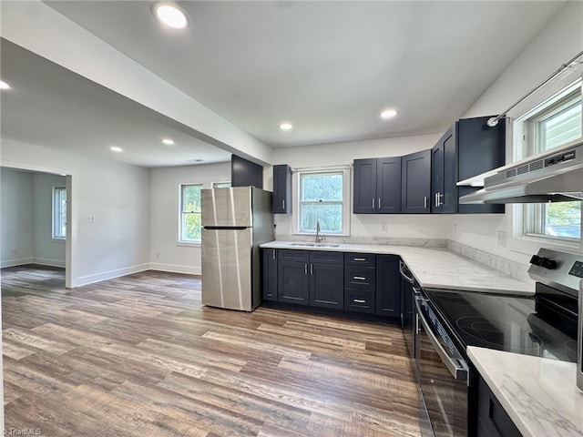 1101 Forrest St, High Point, NC 27262 - kitchen featuring appliances with stainless steel finishes, a sink, light stone counters, light wood-style floors, and recessed lighting