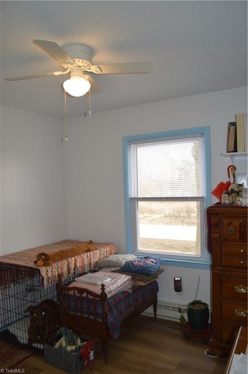 bedroom featuring wood-type flooring and ceiling fan