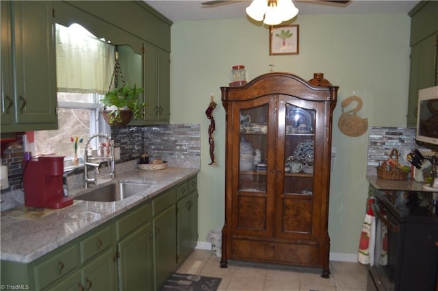 kitchen with range with electric stovetop, sink, decorative backsplash, light tile patterned floors, and ceiling fan