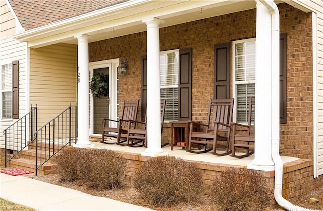 view of exterior entry with covered porch