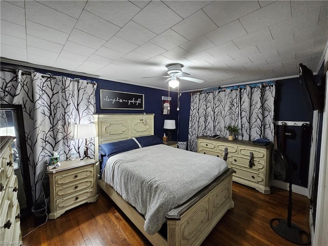 bedroom featuring ceiling fan, ornamental molding, and dark hardwood / wood-style flooring