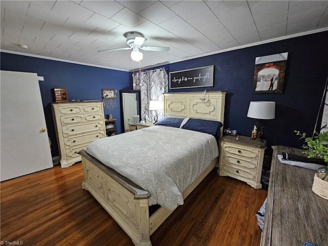 bedroom featuring ornamental molding, ceiling fan, and dark hardwood / wood-style flooring