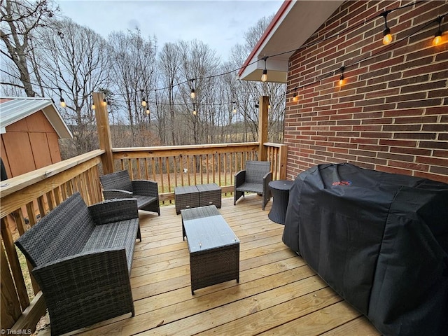 wooden terrace featuring grilling area and an outdoor hangout area