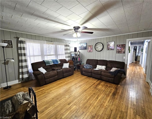 living room with ceiling fan and light wood-type flooring