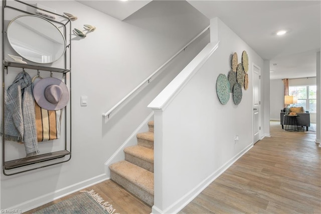 stairs featuring wood-type flooring