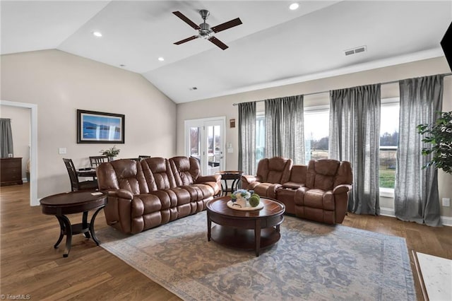 living room featuring french doors, hardwood / wood-style flooring, vaulted ceiling, and ceiling fan