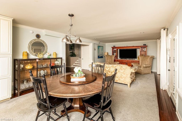 dining room with hardwood / wood-style flooring and ornamental molding