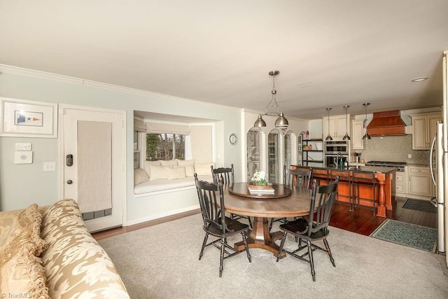 dining space with crown molding and wood-type flooring