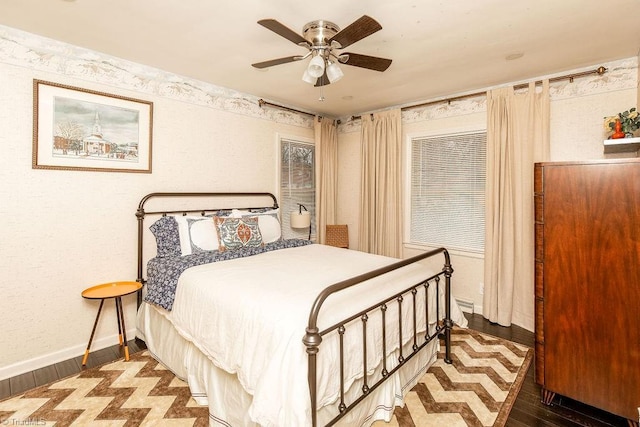 bedroom with dark hardwood / wood-style floors and ceiling fan