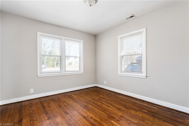 empty room with hardwood / wood-style flooring