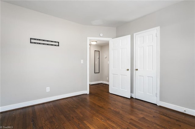 unfurnished bedroom with dark hardwood / wood-style floors