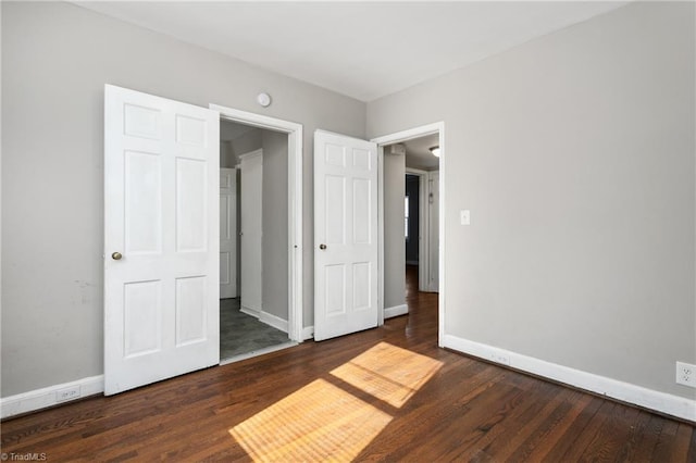 unfurnished bedroom featuring dark hardwood / wood-style floors