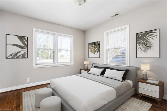 bedroom with dark wood-type flooring