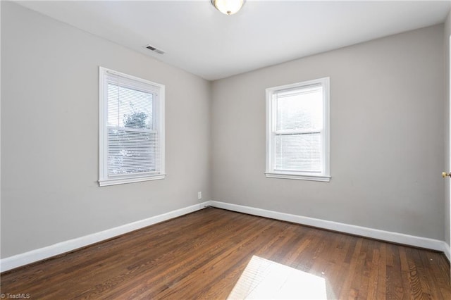 spare room featuring dark wood-type flooring