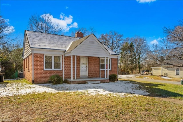 bungalow-style house with a front yard and central AC