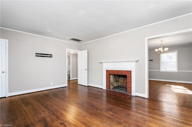 unfurnished living room featuring a brick fireplace, crown molding, and dark hardwood / wood-style floors