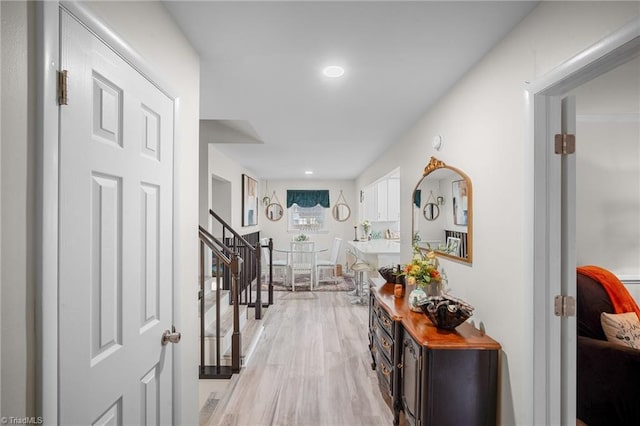 hall with stairway, recessed lighting, and light wood-style floors