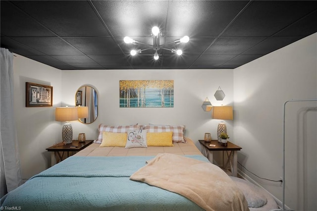 bedroom featuring a notable chandelier