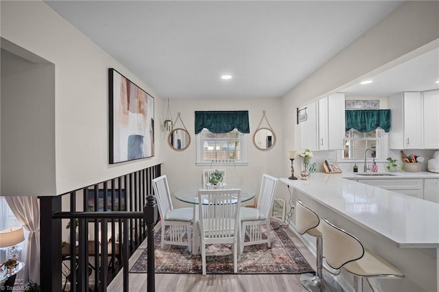 dining room with a wealth of natural light, recessed lighting, and light wood finished floors