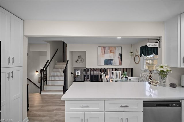 kitchen featuring stainless steel dishwasher and white cabinetry