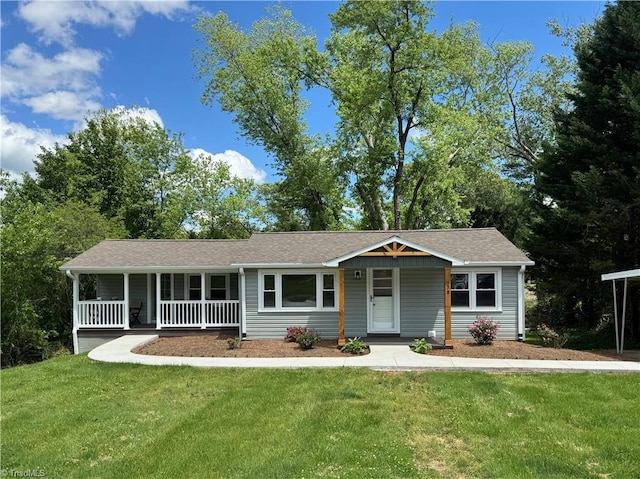 single story home featuring covered porch, a shingled roof, and a front yard