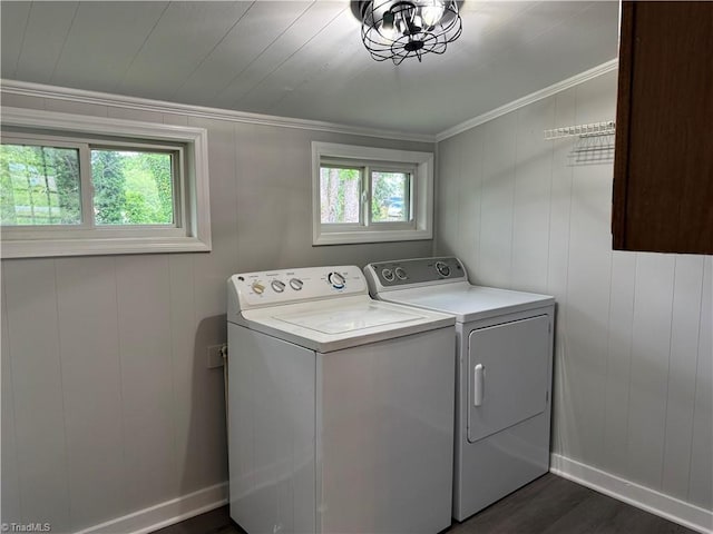 clothes washing area with laundry area, crown molding, dark wood-style flooring, washer and dryer, and baseboards