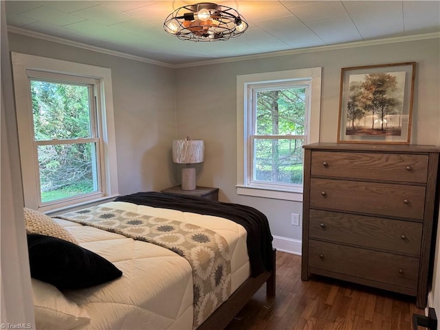 bedroom with baseboards, ornamental molding, dark wood-style floors, and multiple windows