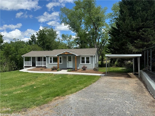 ranch-style house with roof with shingles, a porch, a front yard, a detached carport, and driveway