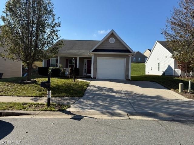 ranch-style home with a front lawn and a garage