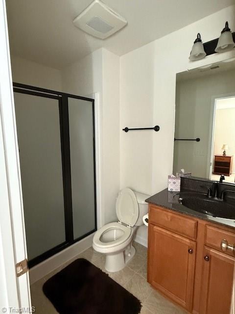 bathroom with walk in shower, vanity, tile patterned floors, and toilet