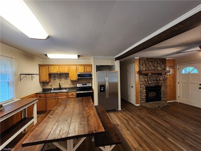 1129 Foxtrot Ct, King, NC 27021 - kitchen with stainless steel appliances, dark countertops, crown molding, dark wood finished floors, and backsplash