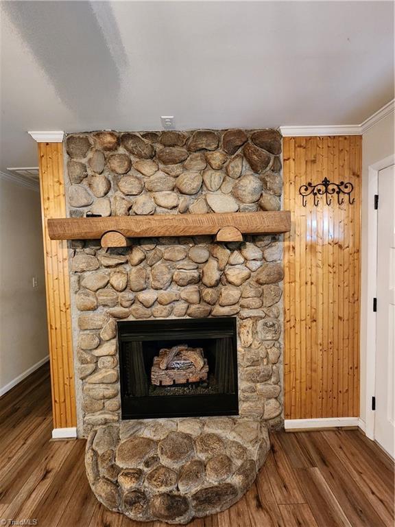 1129 Foxtrot Ct, King, NC 27021 - detailed view of ornamental molding, wood finished floors, baseboards, and a fireplace