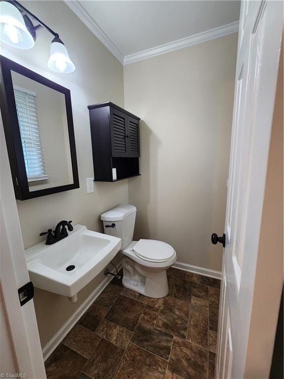 1129 Foxtrot Ct, King, NC 27021 - bathroom featuring crown molding, toilet, stone tile flooring, a sink, and baseboards