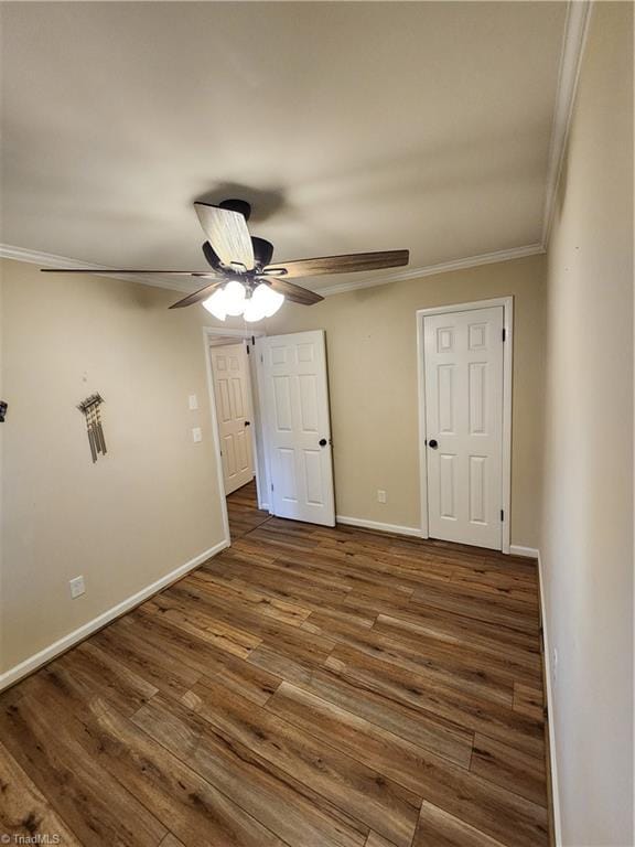 1129 Foxtrot Ct, King, NC 27021 - unfurnished bedroom with ornamental molding, wood finished floors, baseboards, and a ceiling fan