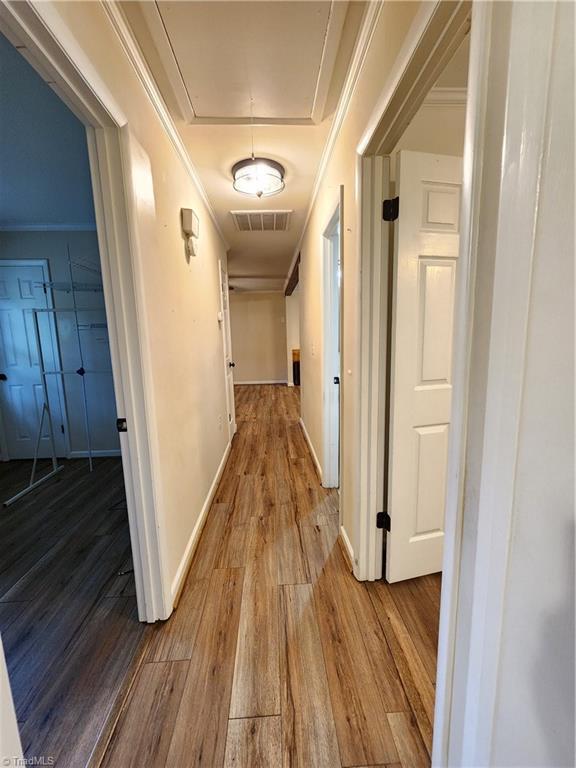 1129 Foxtrot Ct, King, NC 27021 - hall with attic access, wood finished floors, and baseboards