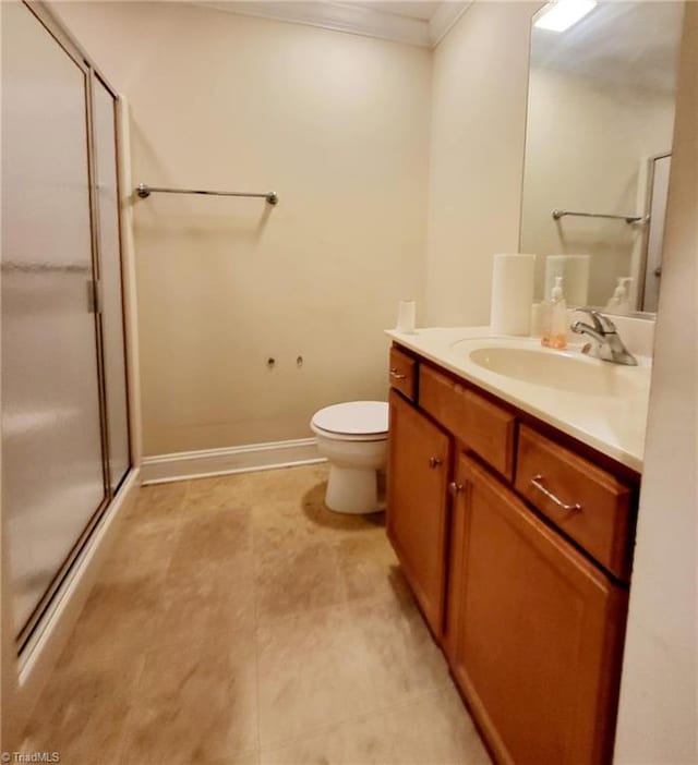 bathroom featuring vanity, an enclosed shower, crown molding, and toilet