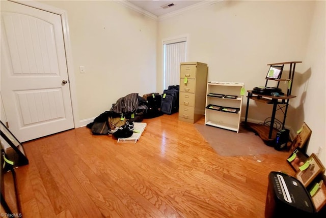 miscellaneous room with ornamental molding and hardwood / wood-style floors