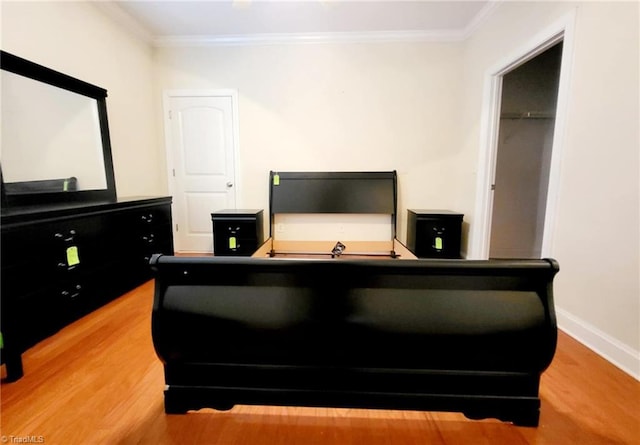 bedroom with hardwood / wood-style flooring and ornamental molding