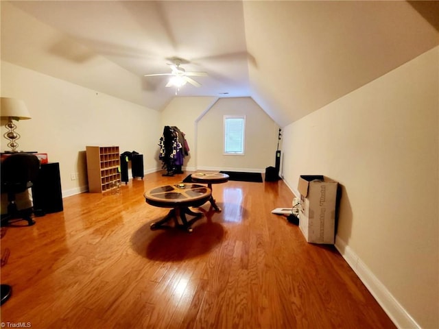 additional living space with ceiling fan, wood-type flooring, and vaulted ceiling