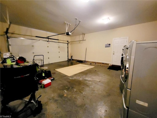 garage with a garage door opener and washer / dryer