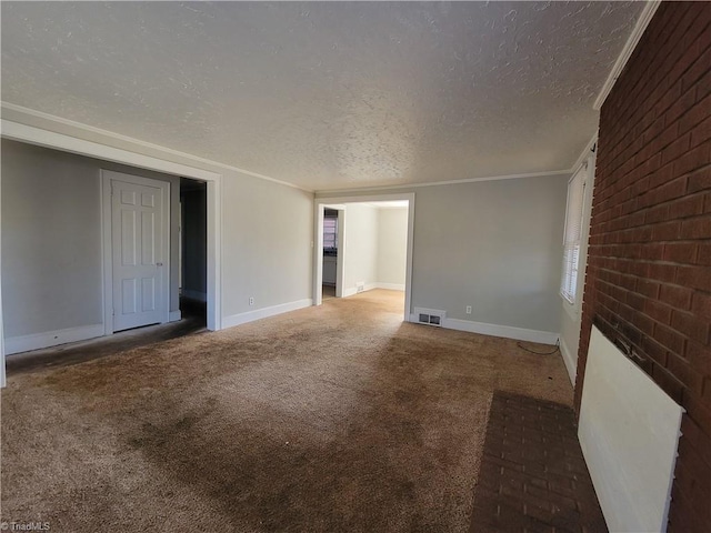 unfurnished room featuring carpet flooring, crown molding, a textured ceiling, and a brick fireplace