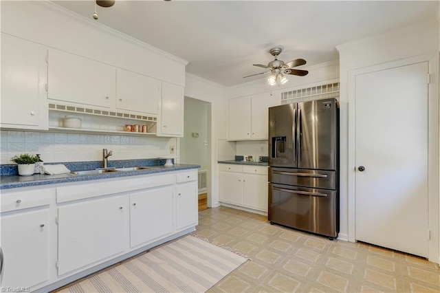 kitchen featuring ornamental molding, white cabinets, stainless steel fridge, and sink