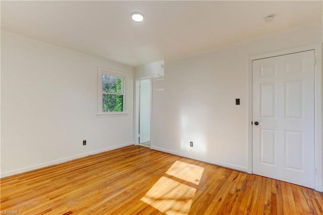 spare room with light hardwood / wood-style flooring