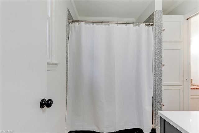 bathroom with vanity and ornamental molding