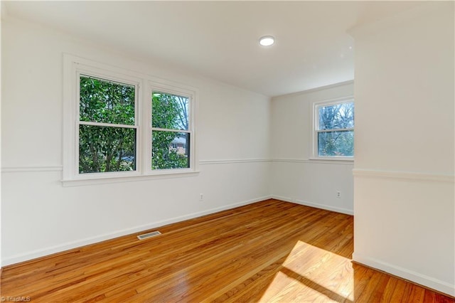 unfurnished room with hardwood / wood-style floors