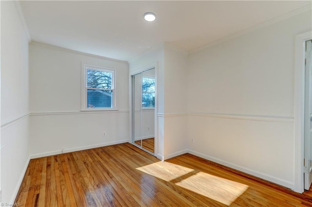 unfurnished room featuring crown molding and light hardwood / wood-style floors